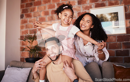 Image of Family, happy and playing airplane on a home sofa for fun, freedom and time together. Portrait of a man, woman and girl kid in a lounge with love, care or happiness for game in a house in Puerto Rico