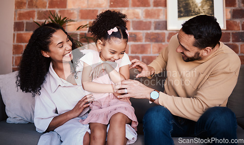 Image of Family, happy and laughing while playing on a home sofa with tickle fun, bonding and time together. A happy man, woman and girl kid in a lounge with love, care and happiness in house in Puerto Rico