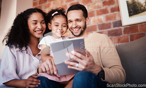 Image of Family, tablet and internet on home sofa for e learning, education and time together. A happy man, woman and kid in a lounge with technology for streaming video, movies or games online in Puerto Rico