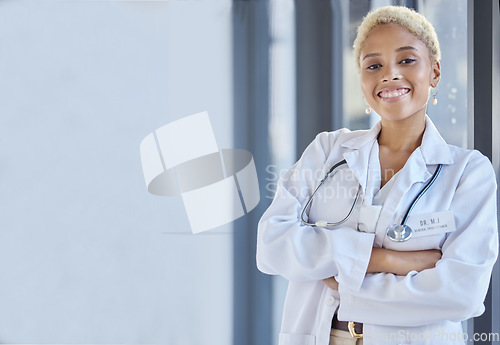 Image of Woman, happy portrait and doctor with arms crossed in hospital for medical services, advice or mockup space in clinic. Surgeon, therapist and healthcare employee smile for pride, trust and consulting