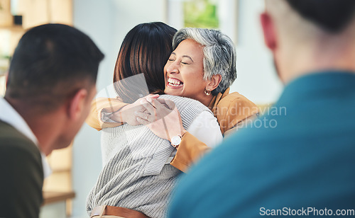 Image of Business people, women and hug in group therapy in office, care or bonding for mental health with smile. Corporate men, staff and colleagues with embrace for team building, welcome and happy together