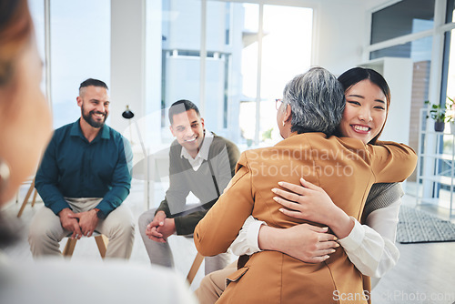 Image of Business people, women and hug in group therapy with care, love and bonding for mental health in workplace. Corporate men, staff and colleagues with smile for team building, diversity and gratitude