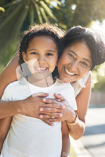 Image of Portrait, kid or happy grandmother hug outdoor for bonding with love, support or care in retirement. Face, girl child or mature grandma with smile, peace or trust on family holiday vacation to relax