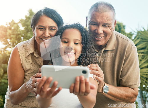 Image of Girl child, grandparents and selfie in garden, backyard or park with smile, hug and care for post on social media. Senior man, woman and female kid with photography, profile picture or memory on blog