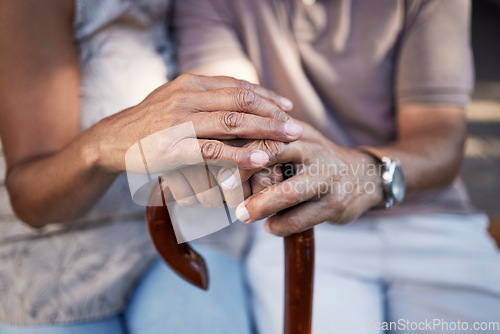 Image of Senior couple, hands and cane in support, retirement and solidarity in marriage. Walking stick, people with a disability and man and woman in comfort, trust or love, care or empathy in house together