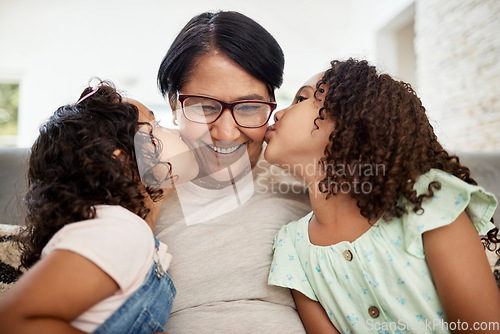 Image of Kids kissing their grandmother on the cheek with care, love and happiness while relaxing in the living room. Smile, happy and senior woman hugging girl children for bonding together at family home.