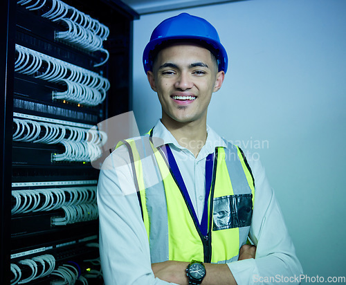 Image of Engineering, portrait and man with smile in server room for network maintenance, software upgrade and programming cables. IT technician, electrician or arms crossed in data center for database backup