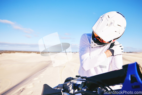 Image of Stretching, shoulder pain and person on motorbike with a strain or injury in desert ready for extreme sports. Performance, training and hurt rider in nature for exercise with motorcycle on dirt road