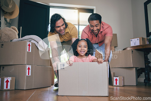 Image of Happy, family fun and box moving with child and gay parents in new home with cardboard package. Dad smile, kid and lgbt people together with youth game and property love in a house helping father