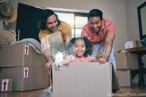 Image of New home, girl and box with parents, push and gay dad with games, portrait and playing on floor with moving. LGBTQ men, female child and cardboard package for car, airplane or driving in family house