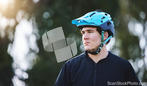 Image of Thinking, nature and a man with a helmet for cycling, training for a triathlon or sports idea. Fitness, focus and a male cyclist or athlete with a vision for a marathon, travel or cardIo workout