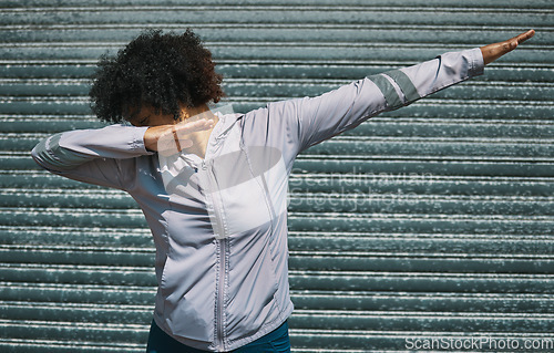 Image of Dabbing, dance and a person on a city wall for hip hop, celebration or fitness. Urban, sports and a female athlete moving for workout, exercise success or training in a town for outdoor cardio