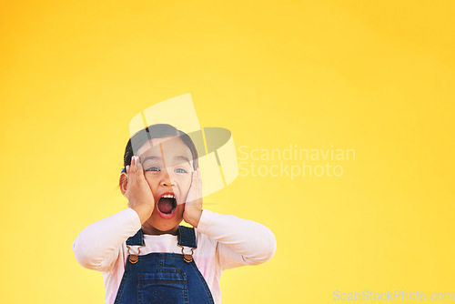 Image of Wow, fashion and hands on face of girl child in studio with deal, sale or giveaway promo on yellow background. Excited, surprise and open mouth kid with emoji for news, announcement or competition