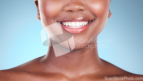 Image of Woman, teeth and smile in dental care, hygiene or treatment against a blue studio background. Closeup of female person mouth in tooth whitening, oral or gum healthcare or cleaning in healthy wellness