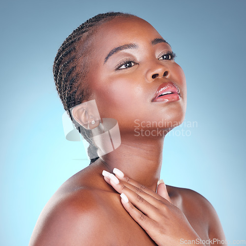 Image of Beauty, skin care and glow of a black woman with dermatology, natural makeup and manicure. Face of African person on blue background with facial cosmetics and hand for soft touch or nails in studio