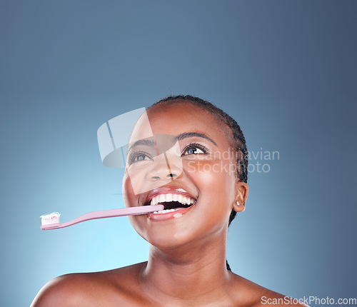 Image of Black woman, face or toothbrush for cleaning teeth on isolated blue background, studio or mockup space. Smile, model or dental toothpaste for gum wellness, breath or mouth hygiene in grooming routine