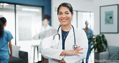 Image of Face, doctor and arms crossed in busy hospital for about us, medical life insurance or wellness support. Smile, happy and healthcare woman in portrait, confidence trust or clinic medicine leadership