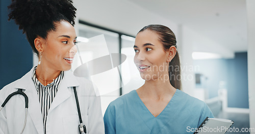 Image of Women doctors, talking or walking in hospital in teamwork, nurse collaboration or surgery research. Smile, happy or healthcare workers in planning, communication or discussion for medicine treatment