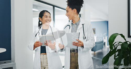 Image of Talking doctors, walking or tablet in busy hospital, teamwork or collaboration for surgery planning, medicine or life insurance app. Smile, happy or planning healthcare women on technology research