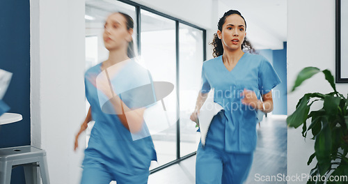 Image of Doctors, nurses or running in hospital emergency, patient crisis or pager call in ICU stress, trauma fail or diversity clinic. Healthcare women, rushing or run in medical hallway to code blue problem