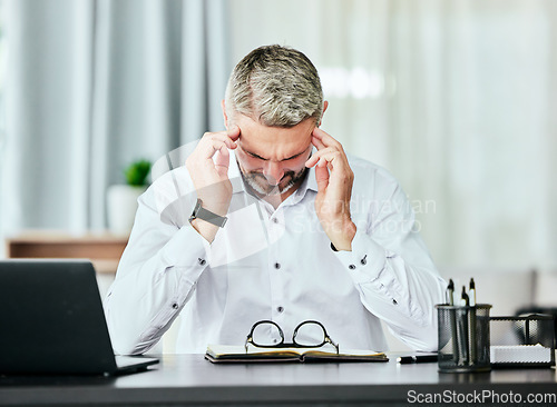 Image of Stress, anxiety and headache with a business man in the office, working on a laptop for his report deadline. Burnout, mental health and tax manager overwhelmed by a bankruptcy or financial crisis