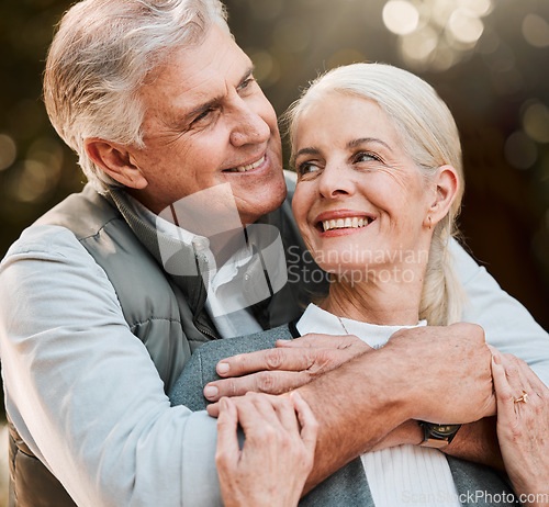 Image of Happy, love and senior couple hug at a park, free and enjoy travel, holiday or weekend. Face, smile and elderly man embrace woman in forest, bond and having fun on retirement trip outdoor together