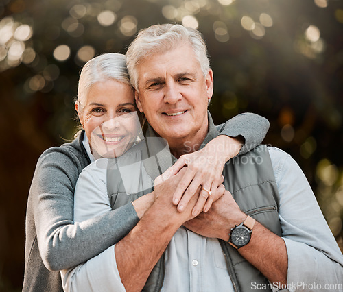 Image of Happy, portrait and senior couple hug at a park, free and enjoy travel, holiday or weekend outdoor. Face, smile and elderly woman embrace man in forest, bond or having fun on retirement trip together