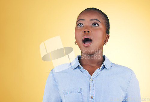 Image of Surprise, wow or face of black woman in studio on yellow background amazed by retail discount deal. Wtf, omg or mind blown person shocked by sale offer, promotion or news announcement with mouth open