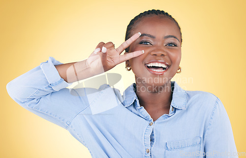 Image of Happy, portrait and a black woman with a peace sign on a studio background for fun personality. Cool, happy and an African girl or young person with a crazy hand gesture isolated on a studio backdrop