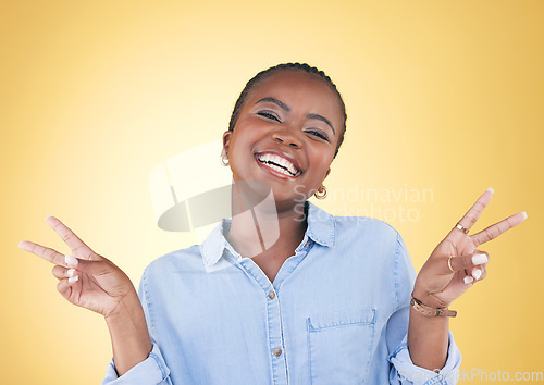 Image of African woman, peace sign and studio portrait with smile, excited face and trendy clothes by yellow background. Young fashion model, happy or student with hand, icon or emoji with vote for opinion