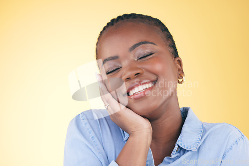 Image of Happy, black woman and skincare, touch and beauty in studio isolated on a yellow background mockup space. Smile, natural and African model in cosmetic facial treatment, health aesthetic and wellness