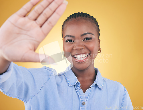 Image of Selfie, smile and portrait of black woman in studio for motivation, social media and influencer. Happy, freedom and profile picture with face of person on yellow background for post and happiness