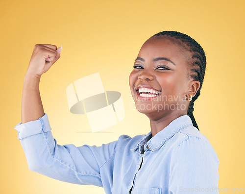 Image of Portrait, strong and black woman flex for power, achievement and challenge on a yellow studio background. Face, happy person and model with strength, arm muscle and success with confidence or winning