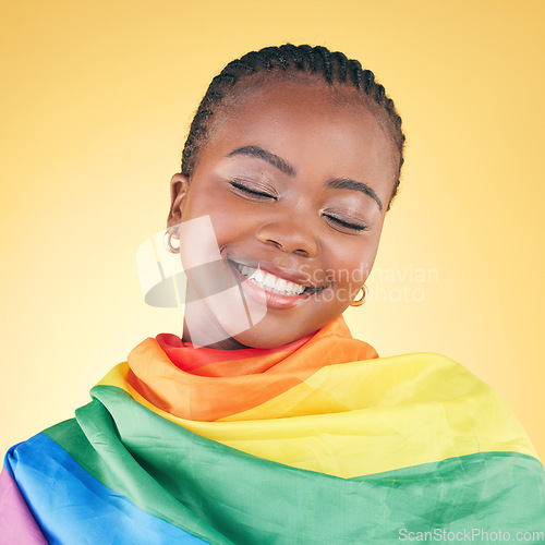 Image of African woman, lgbt flag and studio with smile, thinking and eyes closed for inclusion by yellow background. Young lesbian woman, rainbow cloth or fabric for vote, equality and happy with gay pride