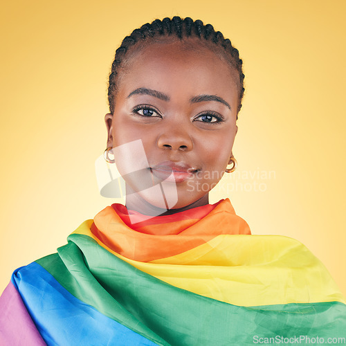 Image of Black woman, portrait, pride flag and lgbtq with lesbian, freedom and support isolated on yellow studio background. Queer movement, community and rainbow, inclusion and transgender with advocate