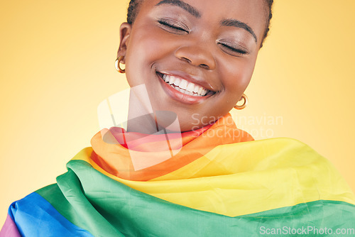 Image of African lesbian woman, pride flag and studio with smile, thinking or inclusion for gay freedom by yellow background. Student girl, rainbow cloth or fabric for vote, equality or happy for lgbtq icon