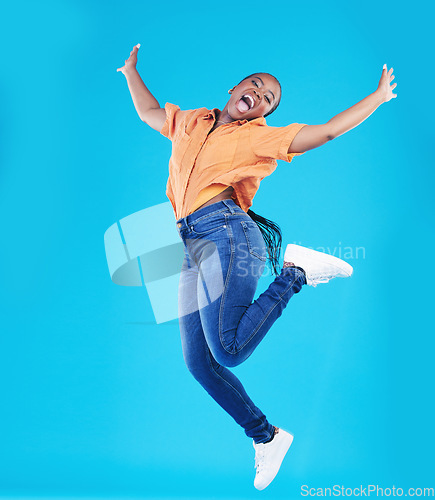 Image of Jump, black woman and excited portrait with motivation in studio from celebration smile. Happy, energy and African female person with promotion and blue background with leap from deal announcement