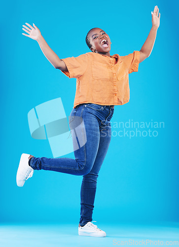 Image of Winner, excited or portrait of black woman jump on blue background with energy, joy or smile in studio. Happy, celebration or African person screaming for freedom, success or winning lottery jackpot