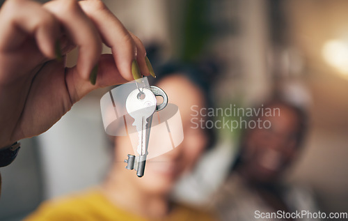 Image of Keys, hand and new home or people moving in together for real estate investment. Rent, mortgage and loan as homeowner celebrate at apartment, property or house with a partner for freedom or security