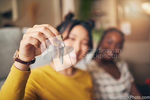 Image of Hand, keys and new home or people moving in together for real estate investment. Rent, mortgage and loan closeup of women friends celebrate at apartment, property or house with a partner for freedom