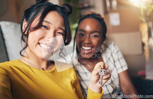 Image of Couple of friends, keys and new home selfie for moving in together for real estate investment. Rent, mortgage and loan of women with smile for social media portrait at apartment or house with partner