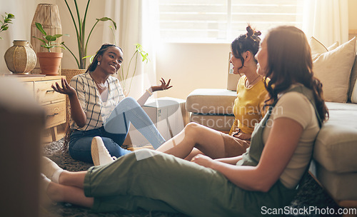 Image of Happy, gossip and friends on a floor relax, talking and bond with advice in house together. Conversation, drama and women with diversity in a living room speaking, chilling and enjoy weekend freedom