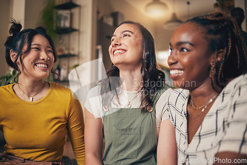 Image of Happy, friends and women in a living room with funny, conversation and bond in their home together. Gossip, smile and people with diversity in a house for reunion, weekend and relax on day off