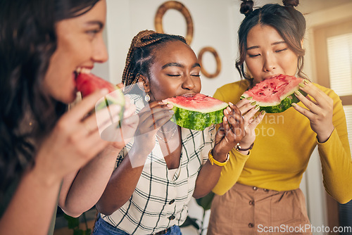 Image of Women, friends and eating watermelon in home for bonding, nutrition and happy lunch together. Healthy diet fruit, sharing and wellness, fresh summer food for friendship and girls in kitchen at party.