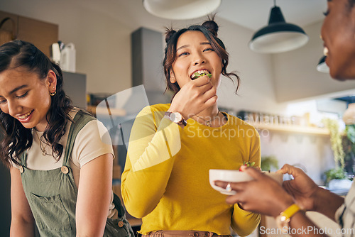 Image of Women, friends and eating healthy food in home for bonding, nutrition and happy lunch together. Fruit diet, sharing and wellness, fresh summer friendship and girls in kitchen with smile at party.