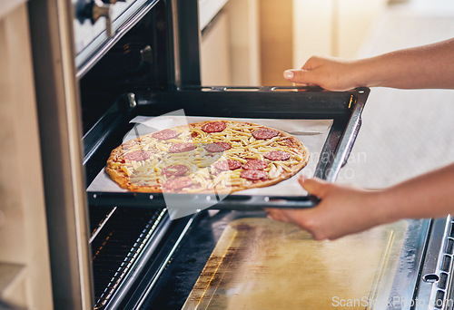 Image of Hands, open oven and cooking pizza for food, restaurant or fast food with skill in home kitchen for baker in Naples. Chef person, dough and tomato sauce for cuisine, culture and preparation process