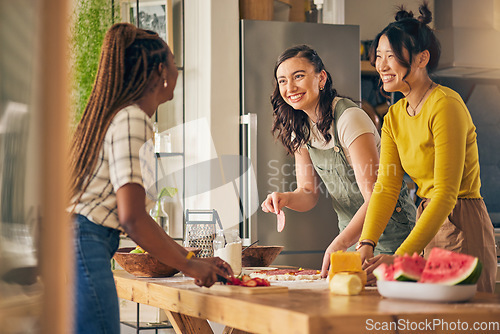 Image of Friends, smile and women cooking pizza in kitchen, bonding and having fun together in home. Happy, girls and baking food, margherita and salami bread at lunch, cheese on meat and brunch in house