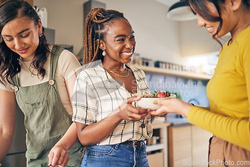 Image of Women, friends and eating fruit in home for bonding, nutrition and happy lunch together. Healthy diet, sharing and wellness, fresh summer food for friendship and girls in kitchen with smile at party.