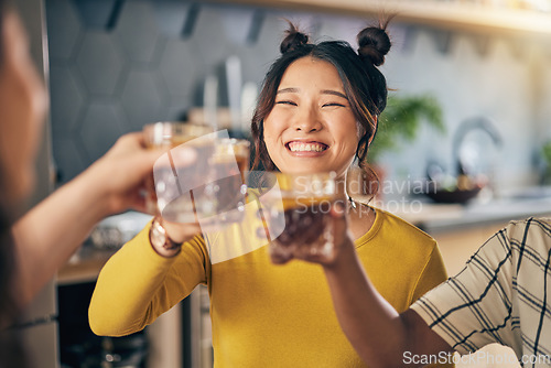 Image of Women group, toast cocktail and home with smile, celebration and party with alcohol, glass or juice. Friends, together and happy for event, culture and success with achievement in kitchen at house