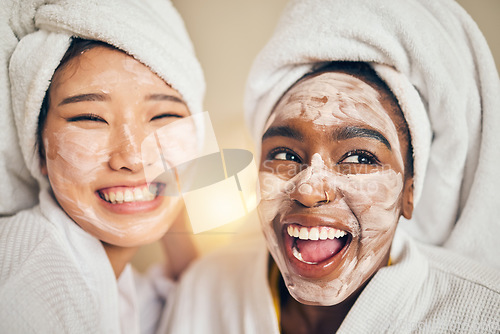 Image of Skincare, face and women friends in a bedroom with mask, application and spa day bonding in their home. Beauty, cream and people with self care sleepover, facial or cosmetic wellness on the weekend